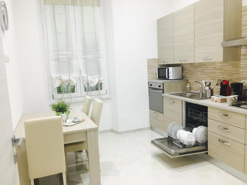 a kitchen with a table and a stove top oven at Queen Chic Apartment in La Spezia