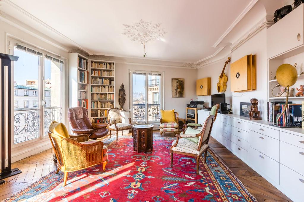 a living room with chairs and a rug at Veeve - Classic Montparnasse in Paris