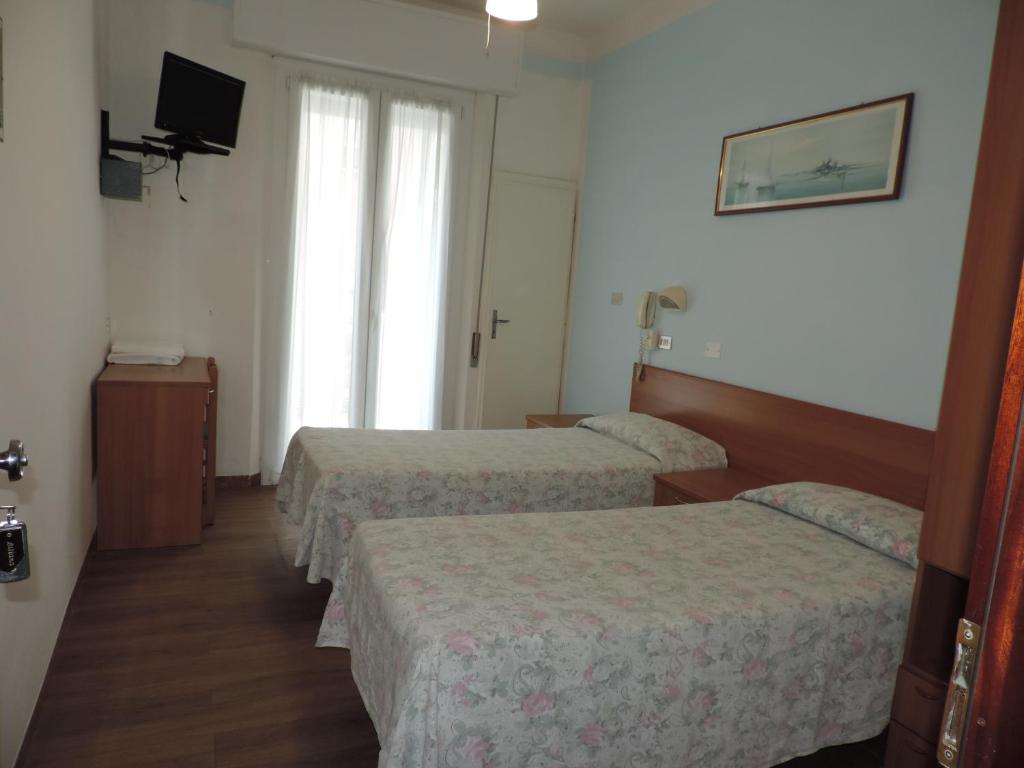 Hotel Liliana tesisinde bir odada yatak veya yataklar