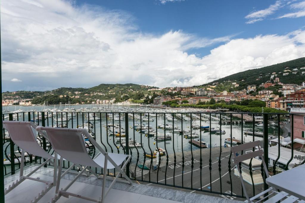 een balkon met stoelen en uitzicht op een haven bij Al Molo Sea View Rooms in Lerici