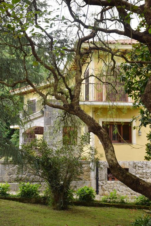 a yellow building with a tree in front of it at Hotel Hontoria in Hontoria