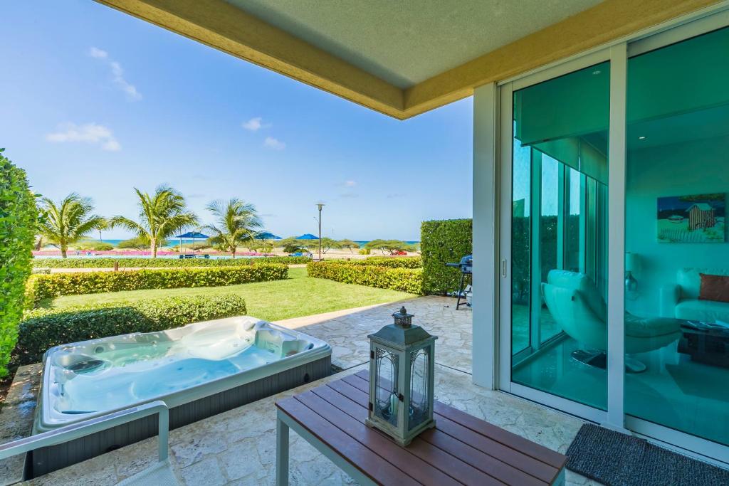 a jacuzzi tub on the patio of a house at Blue Residences in Palm-Eagle Beach