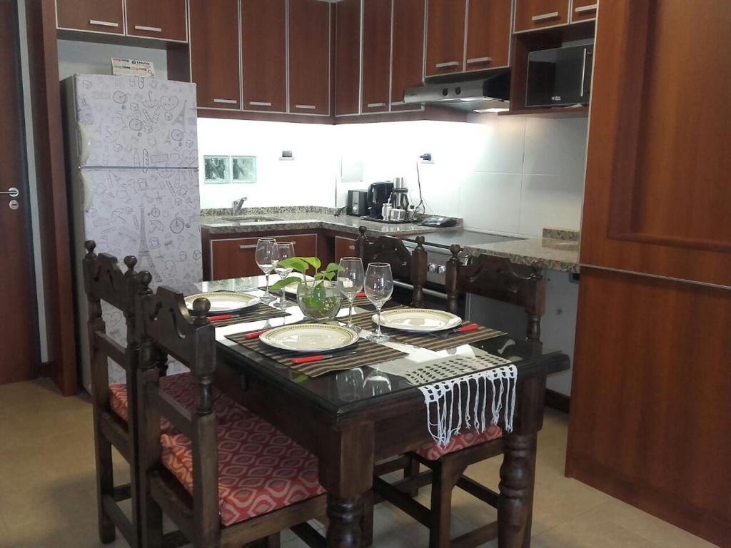 una cocina con una mesa con copas de vino en La Luna- San Juan en San Juan