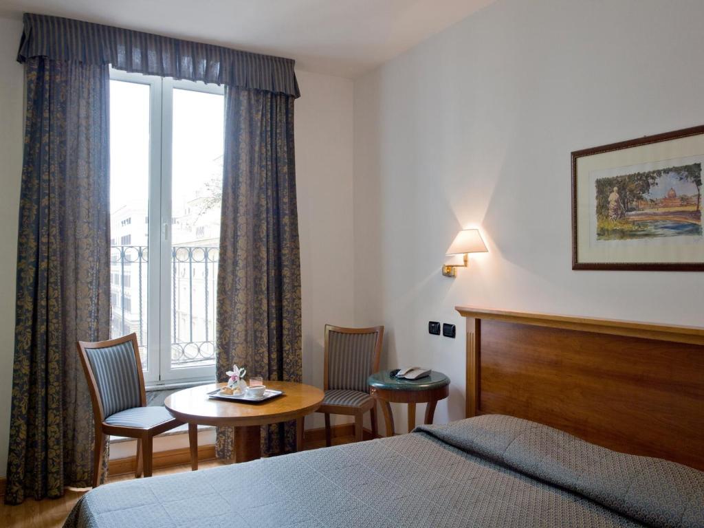 Postel nebo postele na pokoji v ubytování Hotel Diplomatic