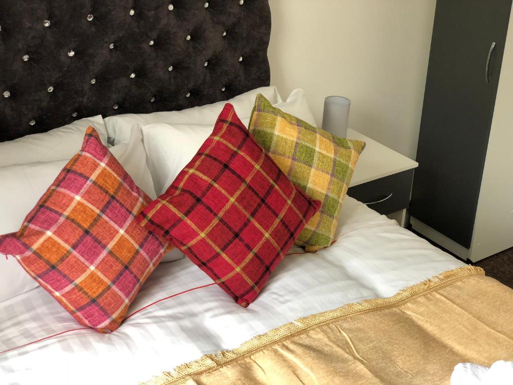 a bed with two pillows on top of it at Islington Apartments in London