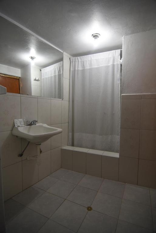 un bagno con lavandino e doccia di Tambo Cusco Inn a Cuzco