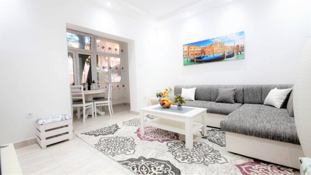 a living room with a couch and a table at Kala Lux Apartment in Tivat