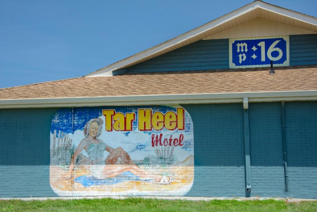 a painting of a woman on the side of a building at Tar Heel Motel in Nags Head