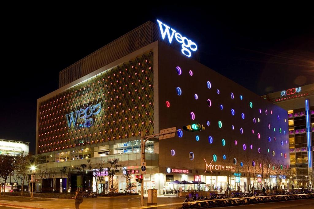 a large building with a sign on it at night at Wego Funtel - Dazhi Branch in Taipei
