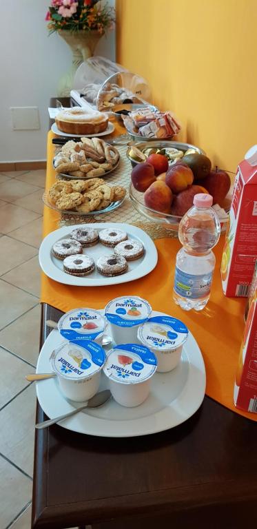 a table with plates of food and bowls of food at B&B La Rosa Lampedusa in Lampedusa