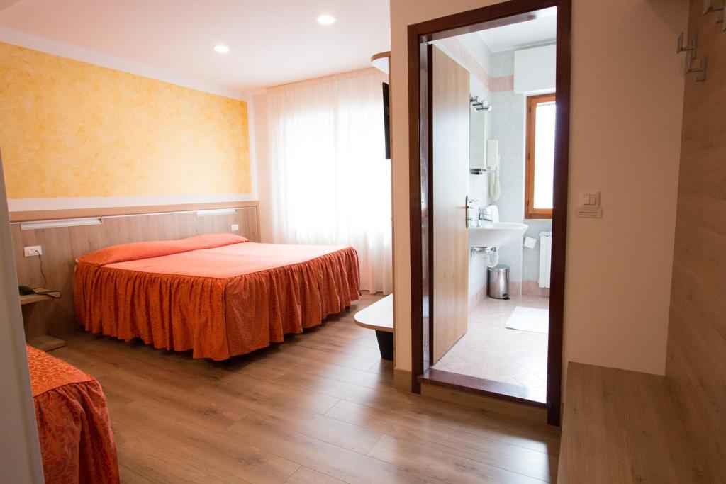 Postel nebo postele na pokoji v ubytování Al Benvenuto Hotel & Restaurant