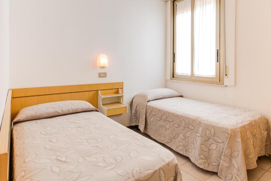 Postel nebo postele na pokoji v ubytování Hotel Splendid