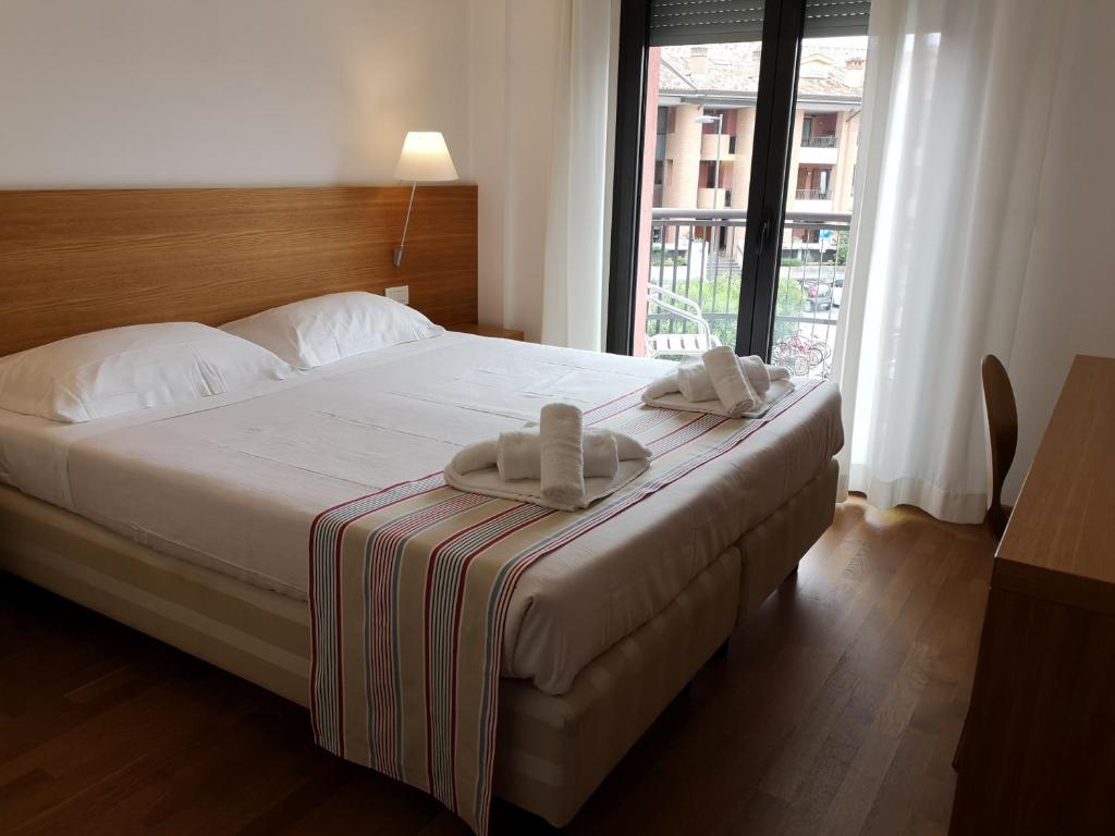 Postel nebo postele na pokoji v ubytování Lacroma Bio Hotel & Apartments