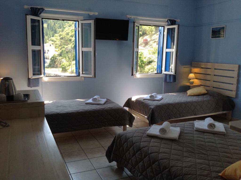 Postel nebo postele na pokoji v ubytování Hotel Nostos