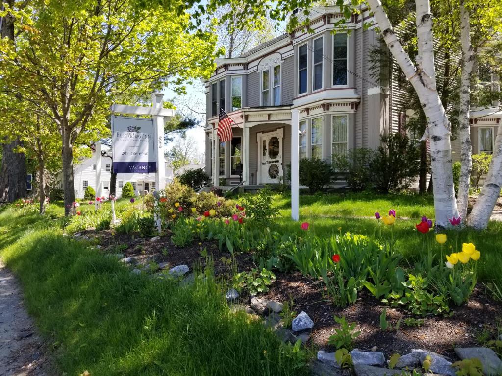 a house with flowers in the front yard at Blackberry Inn in Camden