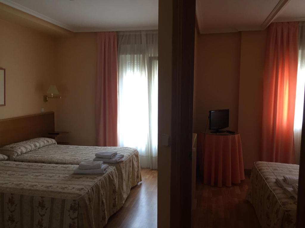 Postel nebo postele na pokoji v ubytování Hotel Benlloch