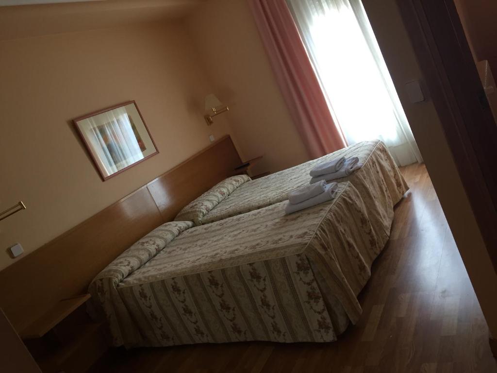 Postel nebo postele na pokoji v ubytování Hotel Benlloch