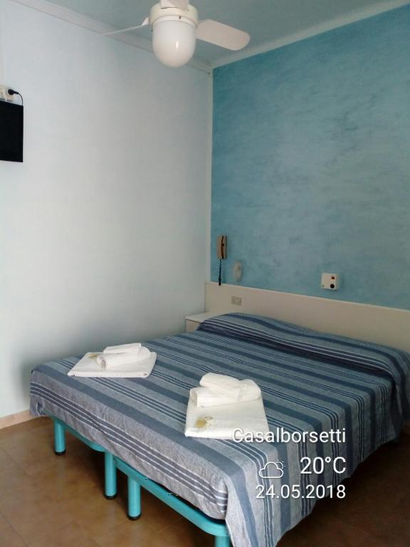 Postel nebo postele na pokoji v ubytování Albergo Rosa & Cosetta