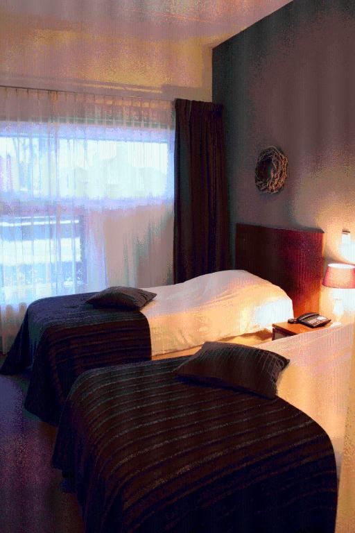 Postel nebo postele na pokoji v ubytování Parkhotel Hugo de Vries