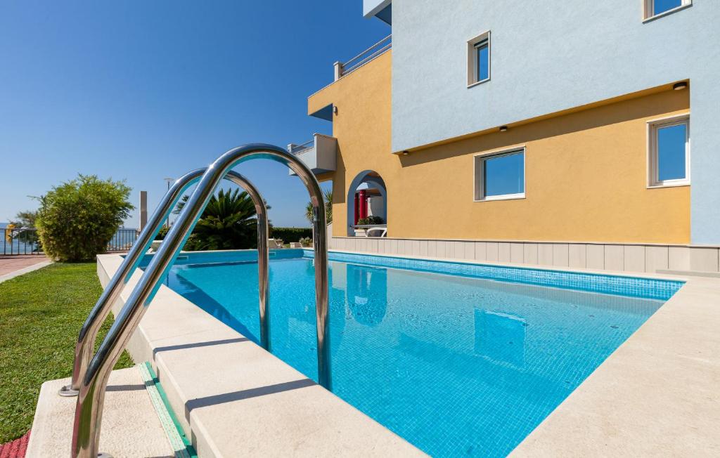 a swimming pool in front of a building at Villa Palmina in Podstrana
