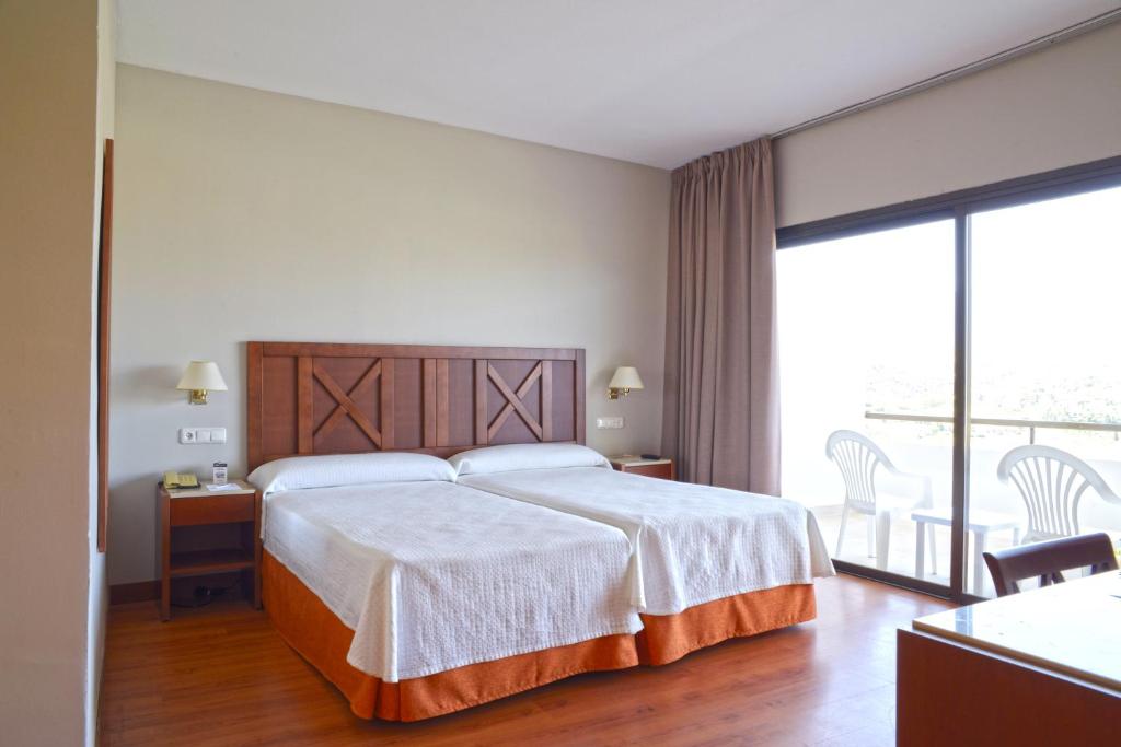A bed or beds in a room at TRH Paraíso