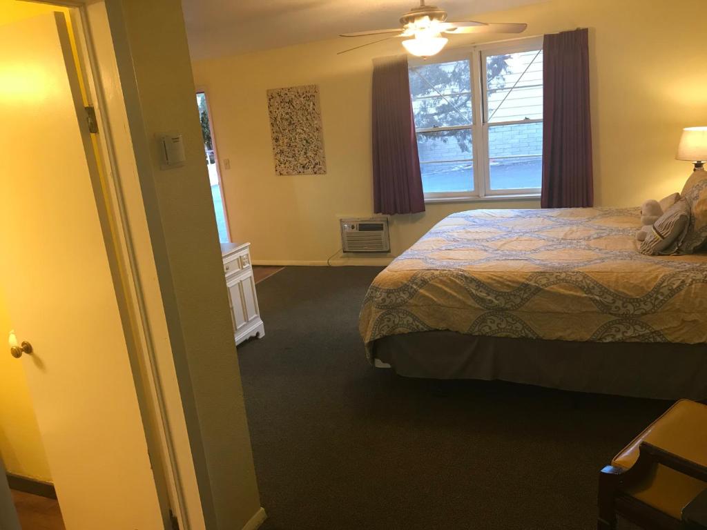 a hotel room with a bed and a window at Caboose Motel & Gift Shop in Durango