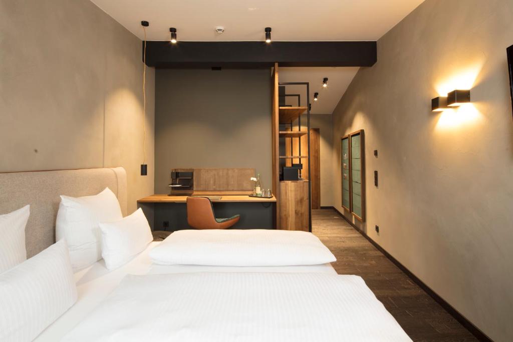 Postel nebo postele na pokoji v ubytování Wailtl Hotel