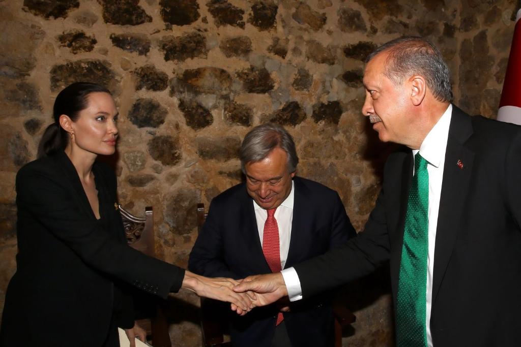 a man and a woman shaking hands with two men at Kasr-i Nehroz Hotel in Midyat