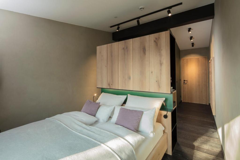 Postel nebo postele na pokoji v ubytování Wailtl Hotel