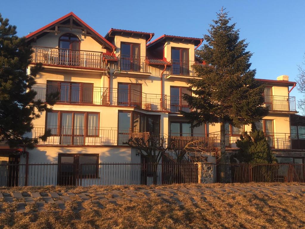 a large building with a fence in front of it at Miramar in Chałupy