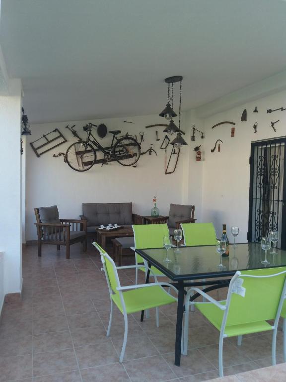 a dining room with a table and chairs and a bike on the wall at Chalet Bri in Peniscola