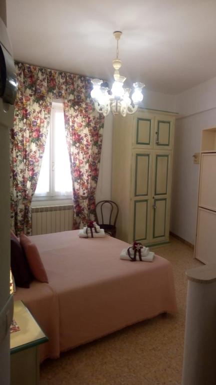 a bedroom with a large bed and a window at camere Caterina in Bonassola