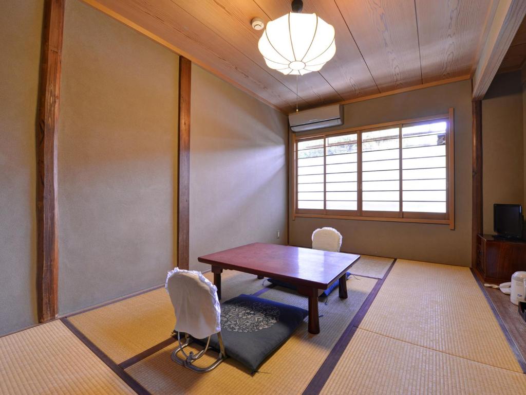 Postel nebo postele na pokoji v ubytování Ryokan Inakatei