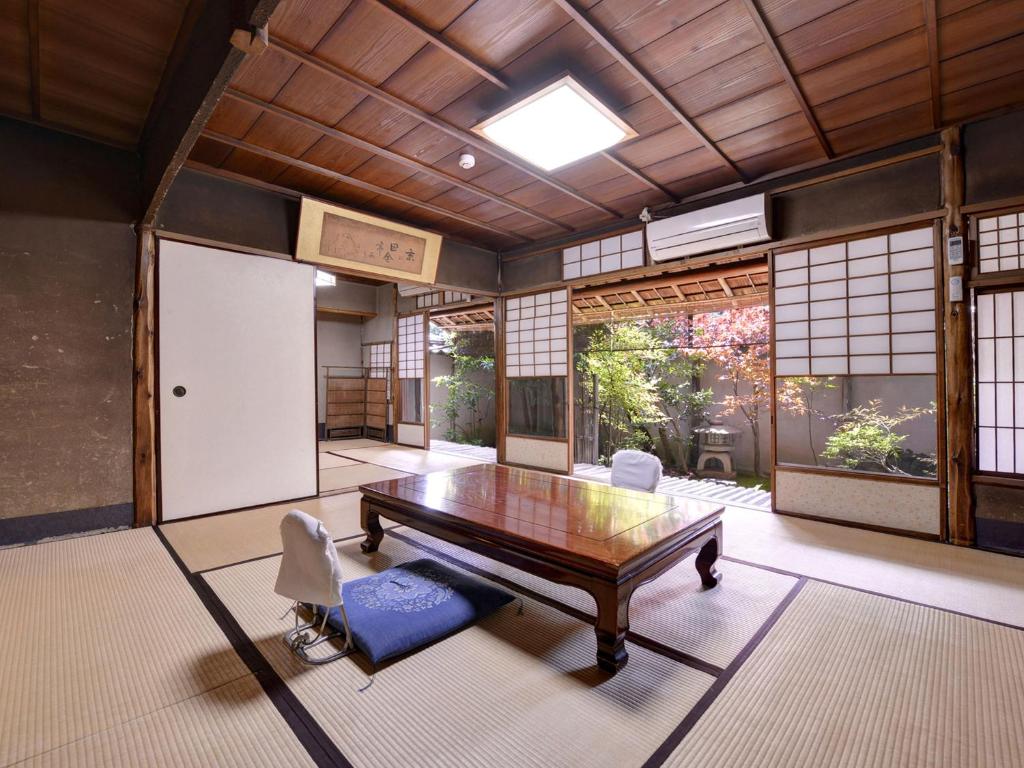 a room with a ping pong table and chairs at Ryokan Inakatei in Kyoto