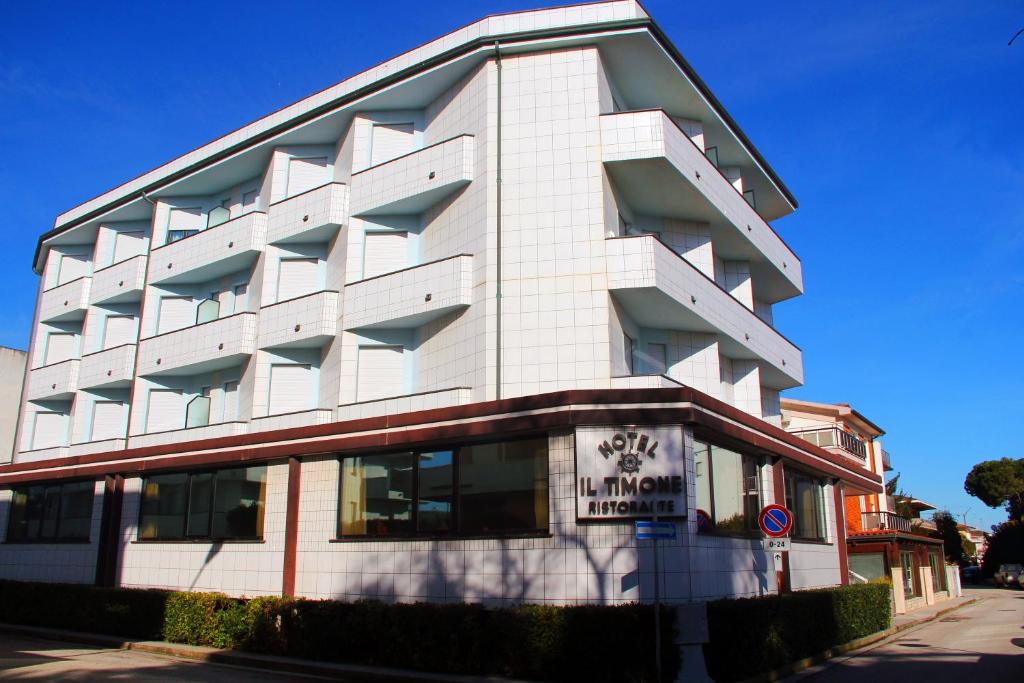 a large white building on the side of a street at Hotel Il Timone in Porto San Giorgio