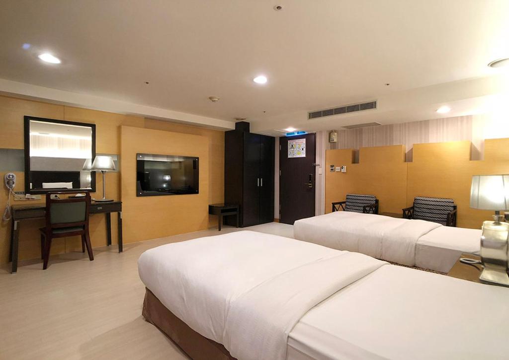Postel nebo postele na pokoji v ubytování Shihzuwan Hotel – Kaohsiung Station