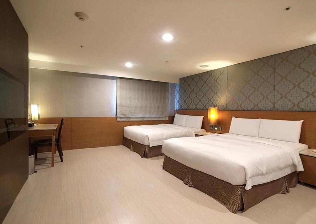 Postel nebo postele na pokoji v ubytování Shihzuwan Hotel – Kaohsiung Station