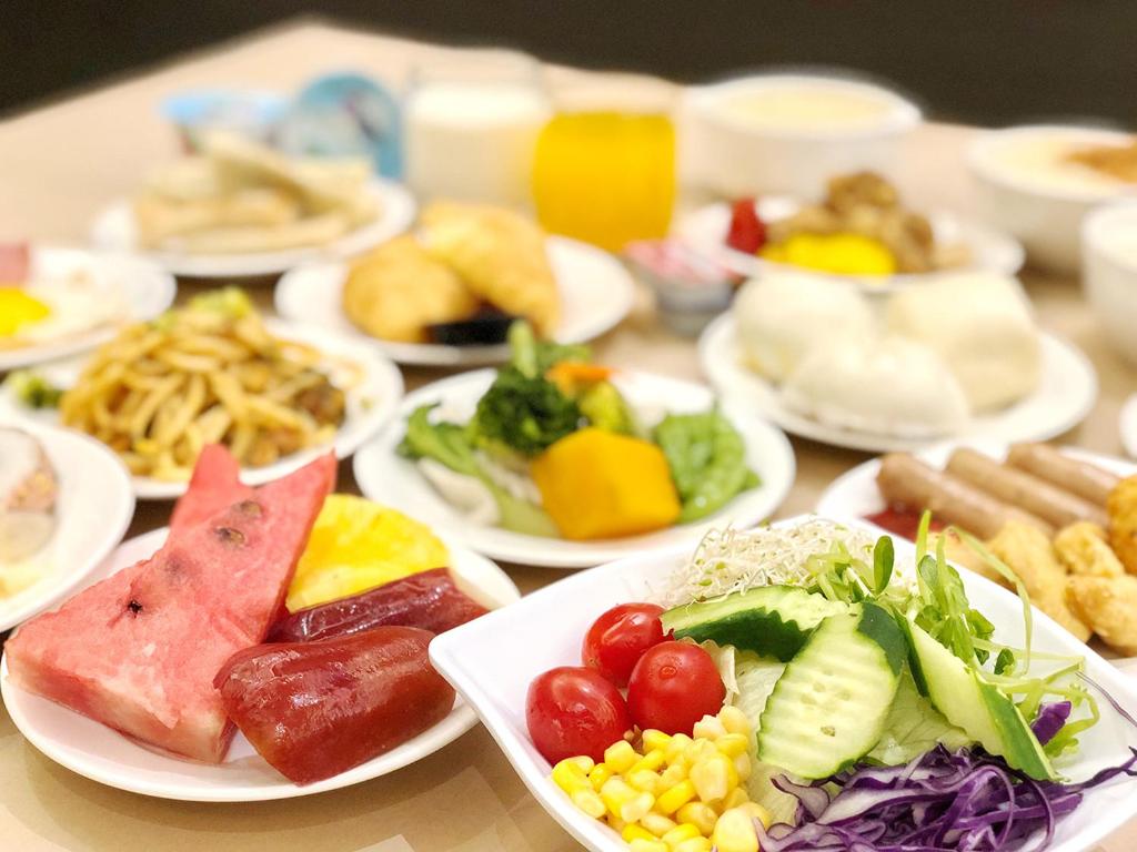 a table with plates of different types of food at Shihzuwan Hotel – Kaohsiung Station in Kaohsiung