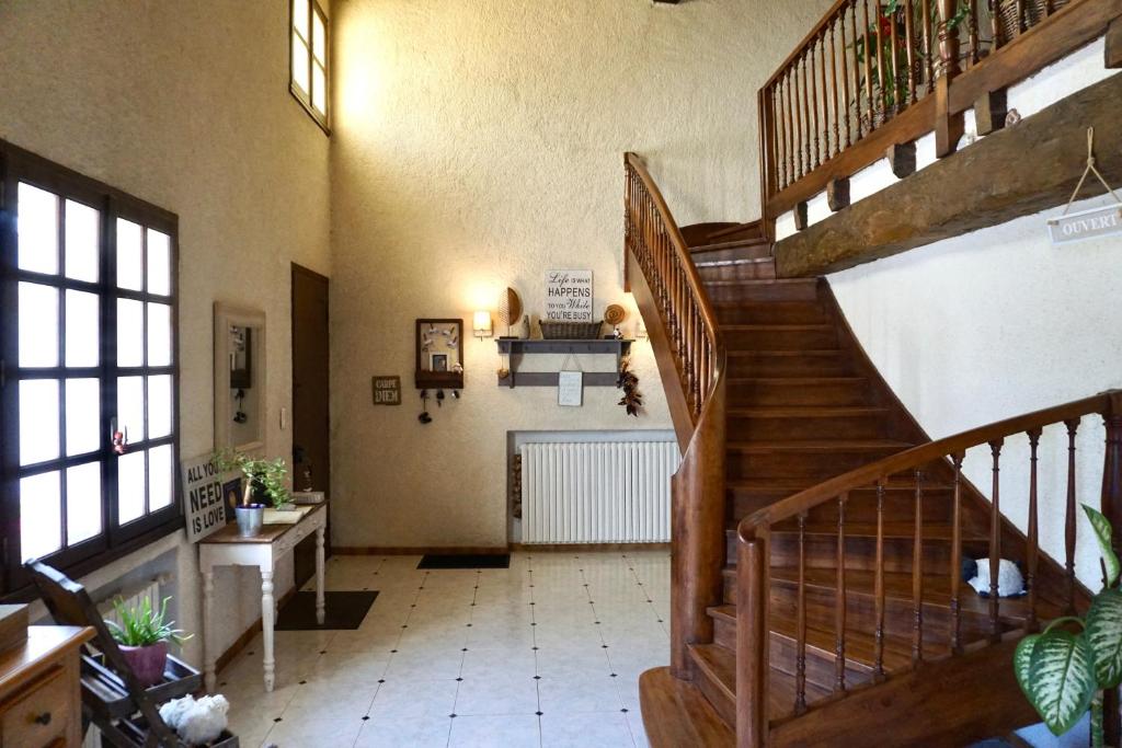 a large hallway with a staircase in a house at La Bergerie De Valerie in Arthès