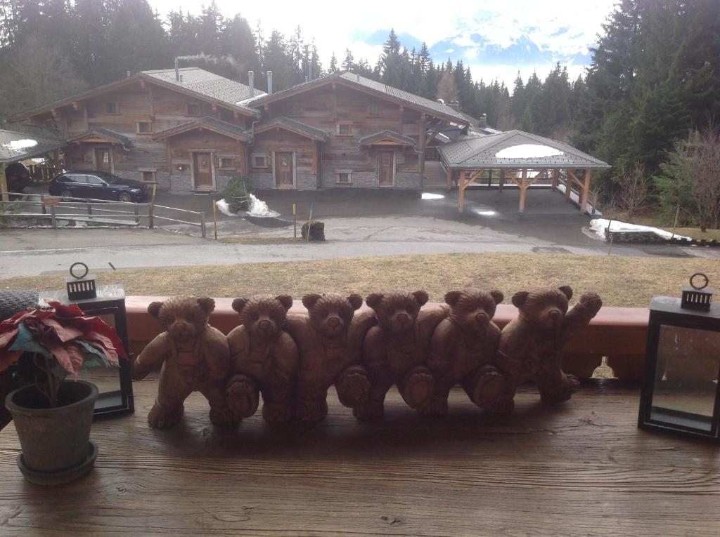 a group of teddy bears sitting on a bench at Petit Ours in Villars-sur-Ollon