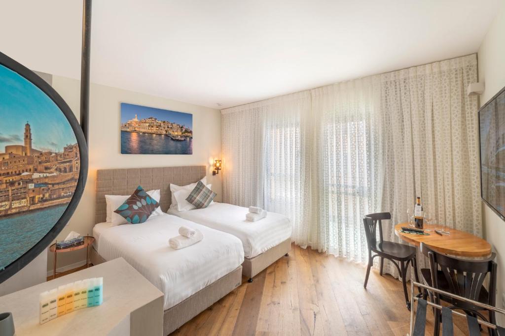Postel nebo postele na pokoji v ubytování Margosa Boutique Hotel Tel-Aviv Jaffa