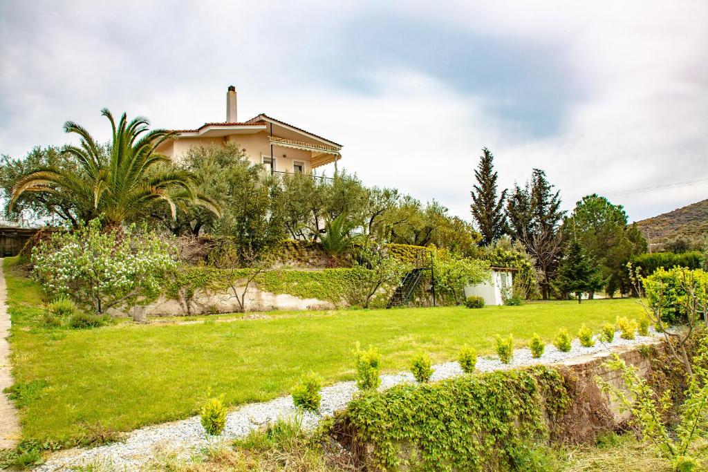 a house on a hill with a green yard at K Residences in Elaiokhórion