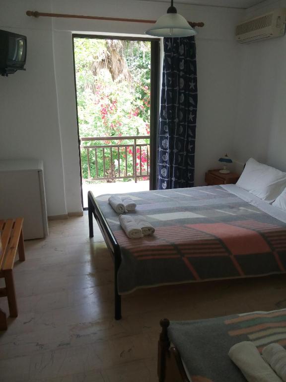 Postel nebo postele na pokoji v ubytování Hotel Dougas