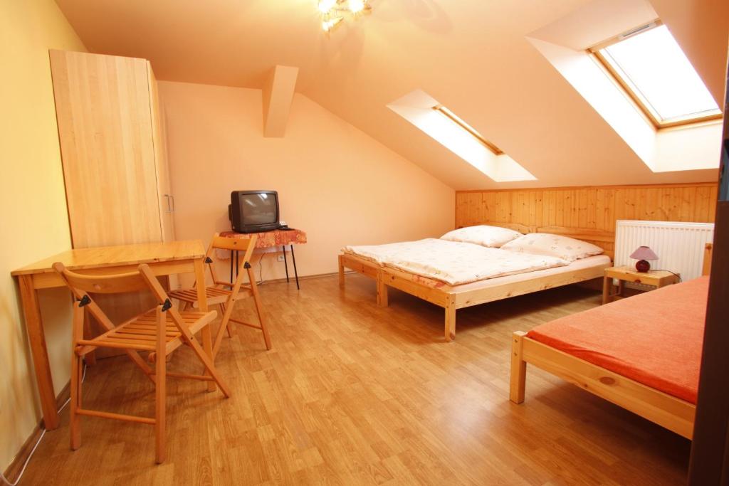 Postel nebo postele na pokoji v ubytování Penzion Na Rozcestí