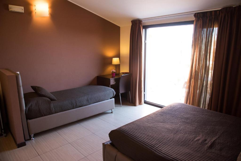 Postel nebo postele na pokoji v ubytování Acitrezza B&B