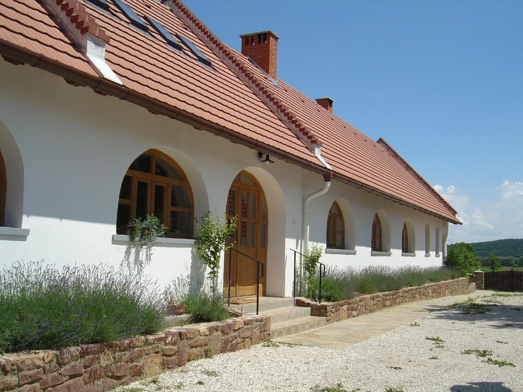 a white building with arches and a red roof at Ferien im Naturschutzgebiet in Kékkút