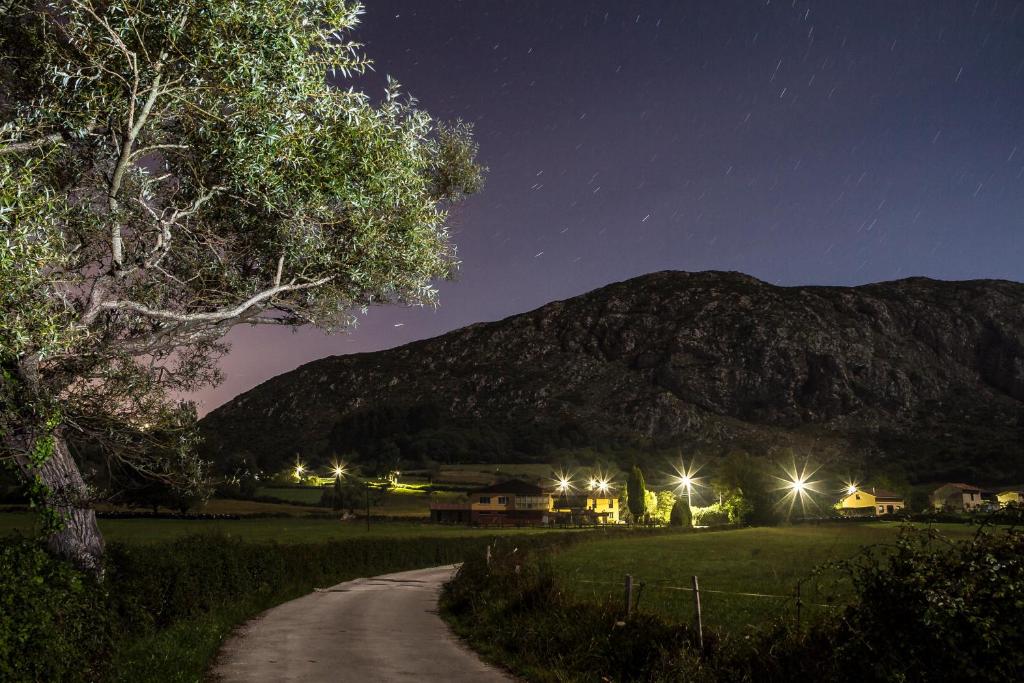 a dirt road at night with a mountain in the background at Casa Rural Peña Careses in Careses