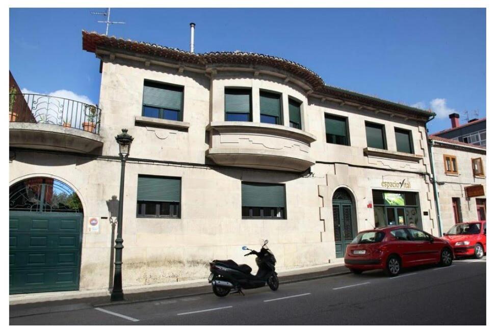 a scooter parked on the street in front of a building at A casa de Carmiña in Gondomar