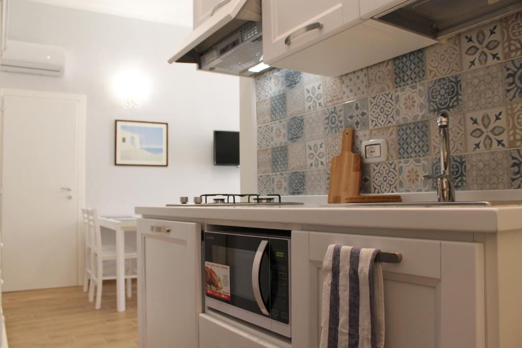 a kitchen with a sink and a stove top oven at Nunzia Sweet Home in Naples