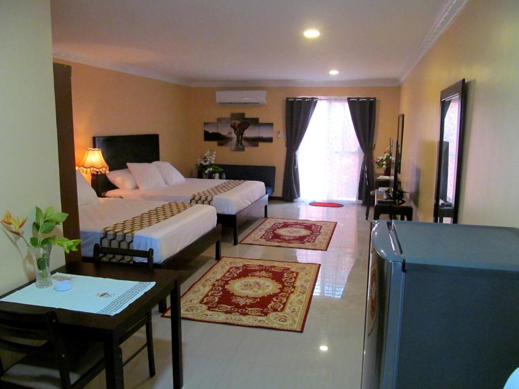 a living room with a bed and a couch at Venezia Suites Resort Panglao in Panglao Island